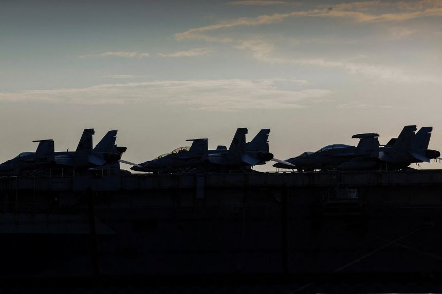 Aircraft on the deck of the US Navy Nimitz-class aircraft carrier USS Abraham Lincoln as it docks for a rest stop at Laem Chabang Port, Thailand, on September 3, following a long deployment in the Middle East.