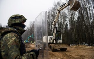 Polish border guards stop a refrigerated lorry carrying migrants