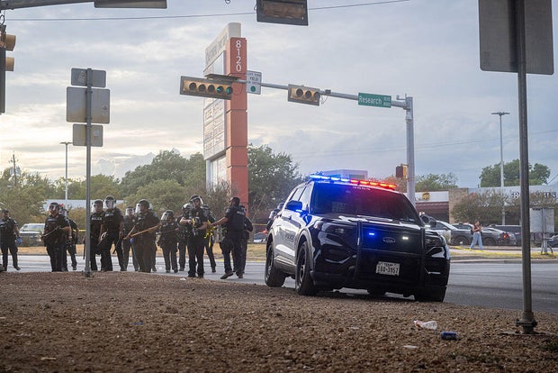 Law enforcement retreat as people protest against ICE on Sept. 20, 2026 in Austin, Texas.