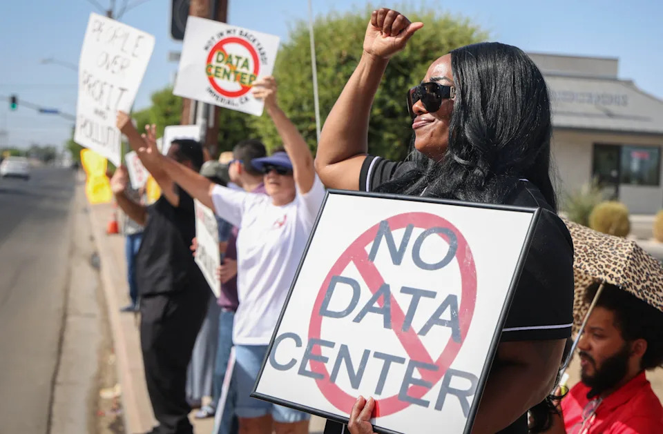 Demonstrators wave signs during a nationwide protest against AI data center expansion in Imperial, California on July 18, 2026.