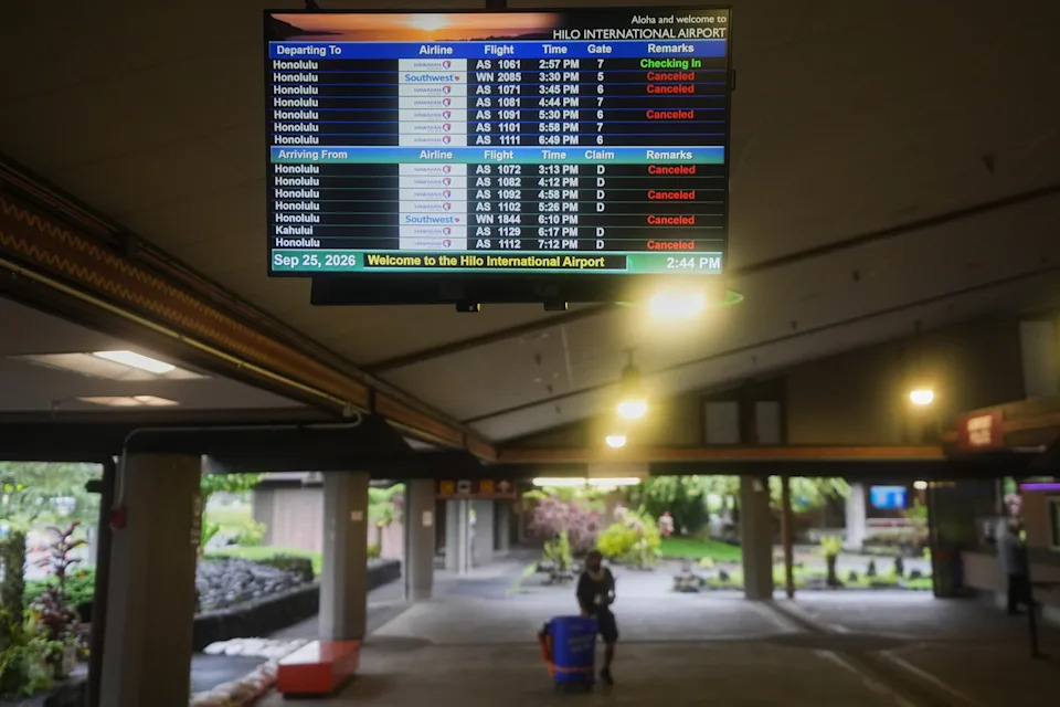 A list of mainly canceled flights are displayed at Hilo International Airport as Hurricane Nolo sits nearby Friday, Sept. 25, 2026, in Hilo, Hawaii. (AP Photo/Gregory Bull)