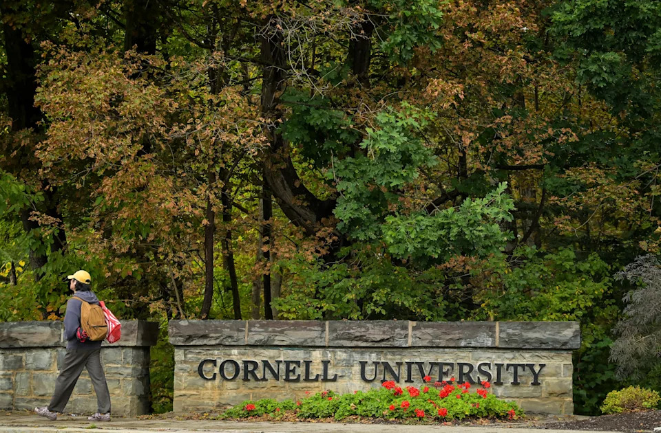A student walks past a Cornell University sign in Ithaca, N.Y., on Sept. 28.