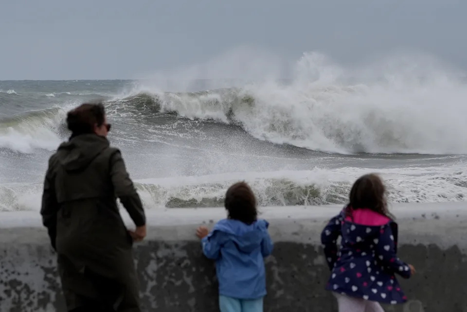 Spectators watch wave break during a nor'easter storm, Saturday, Sept. 26, 2026, in Hampton, N.H. (AP Photo/Robert F. Bukaty)