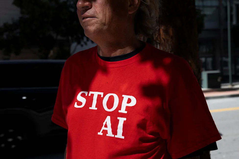 A protester wears a t-shirt that reads " STOP AI" during a rally outside the OpenAI headquarters in San Francisco, Calif., on March 21, 2026.