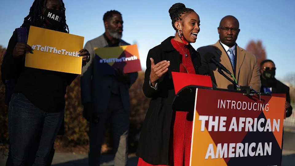 Rep. Shontel Brown speaks as Rep. Jamaal Bowman listens during a news conference.