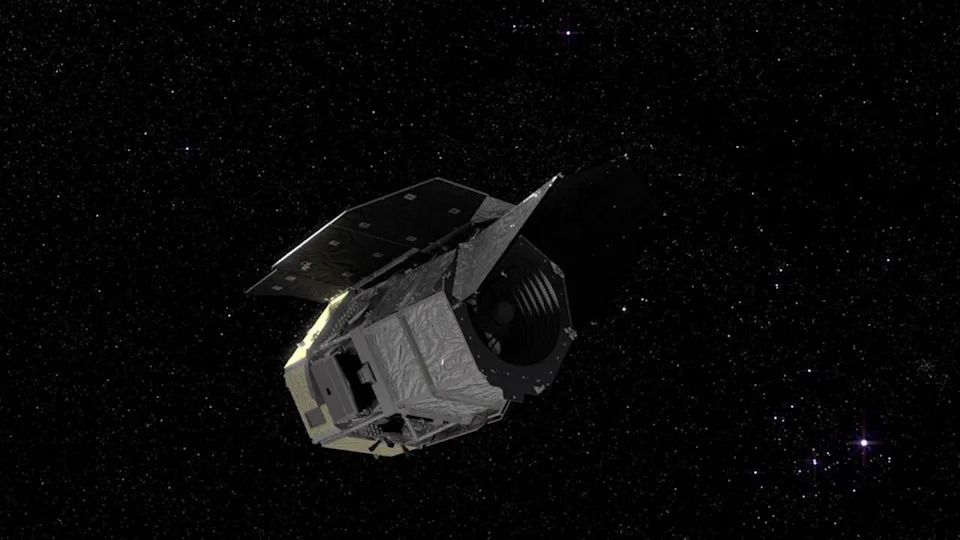 A visualization of a silvery spacecraft in a starry section of space.