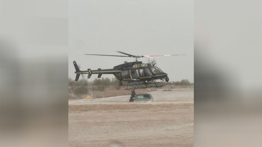 Helicopter rescues two people from a car stranded in floodwater in Goodyear, Arizona.