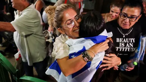 Reuters People hug each other after passengers from the diverted Flydubai flight arrive at Tel Aviv's airport on a repatriation flight. Photo: 30 September 2026