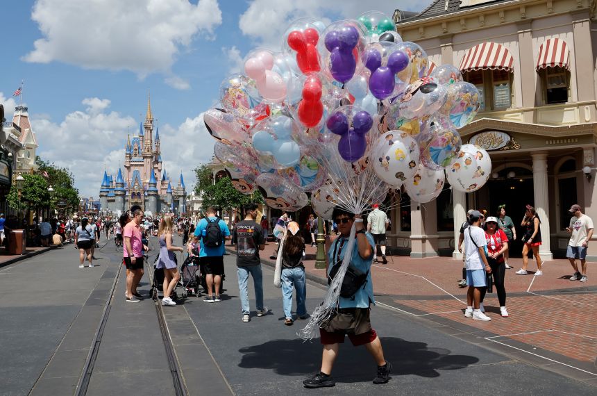 A vendor sells balloons at Walt Disney World on April 3, 2025, in Orlando, Florida.