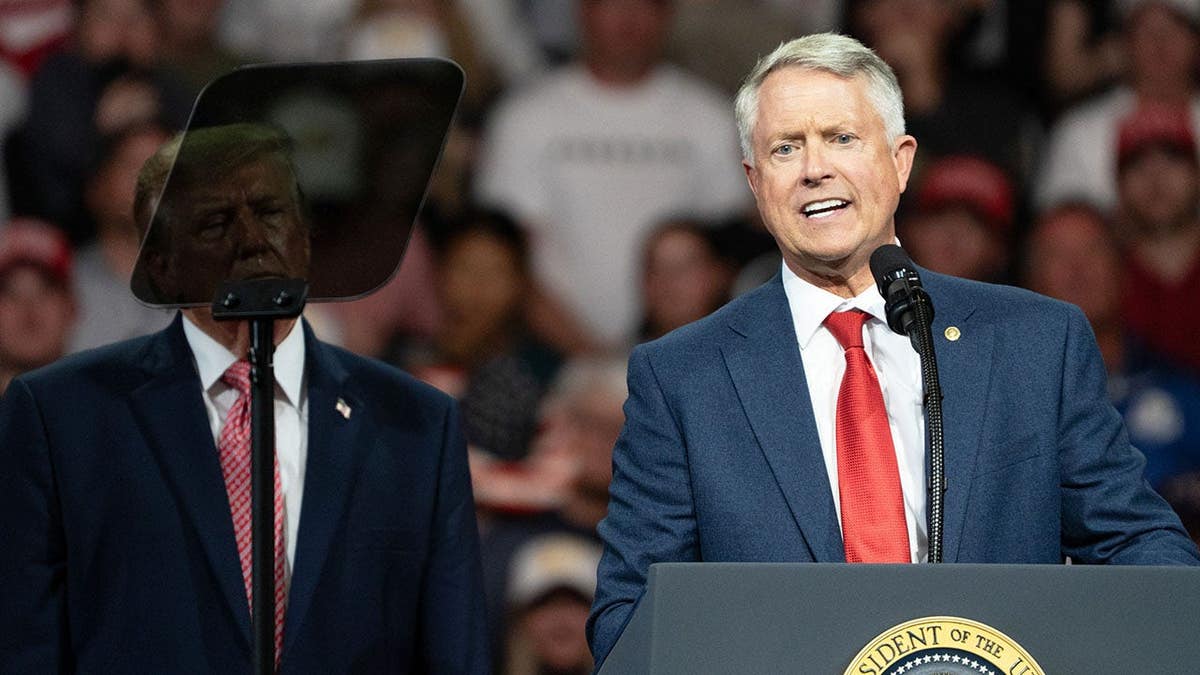 President Donald Trump and Senator Roger Marshall stand together at a campaign event in Park City, Kansas.