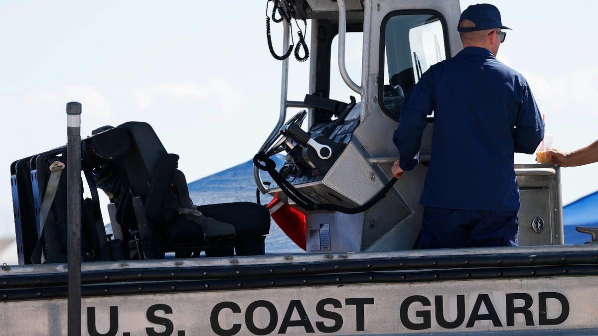 A U.S. Coast Guard emblem is displayed on the side of a boat